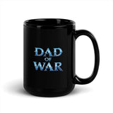 "Black ceramic 'Dad of War' mug with blue lettering, inspired by epic warrior tales, highlighting strength and adventure."